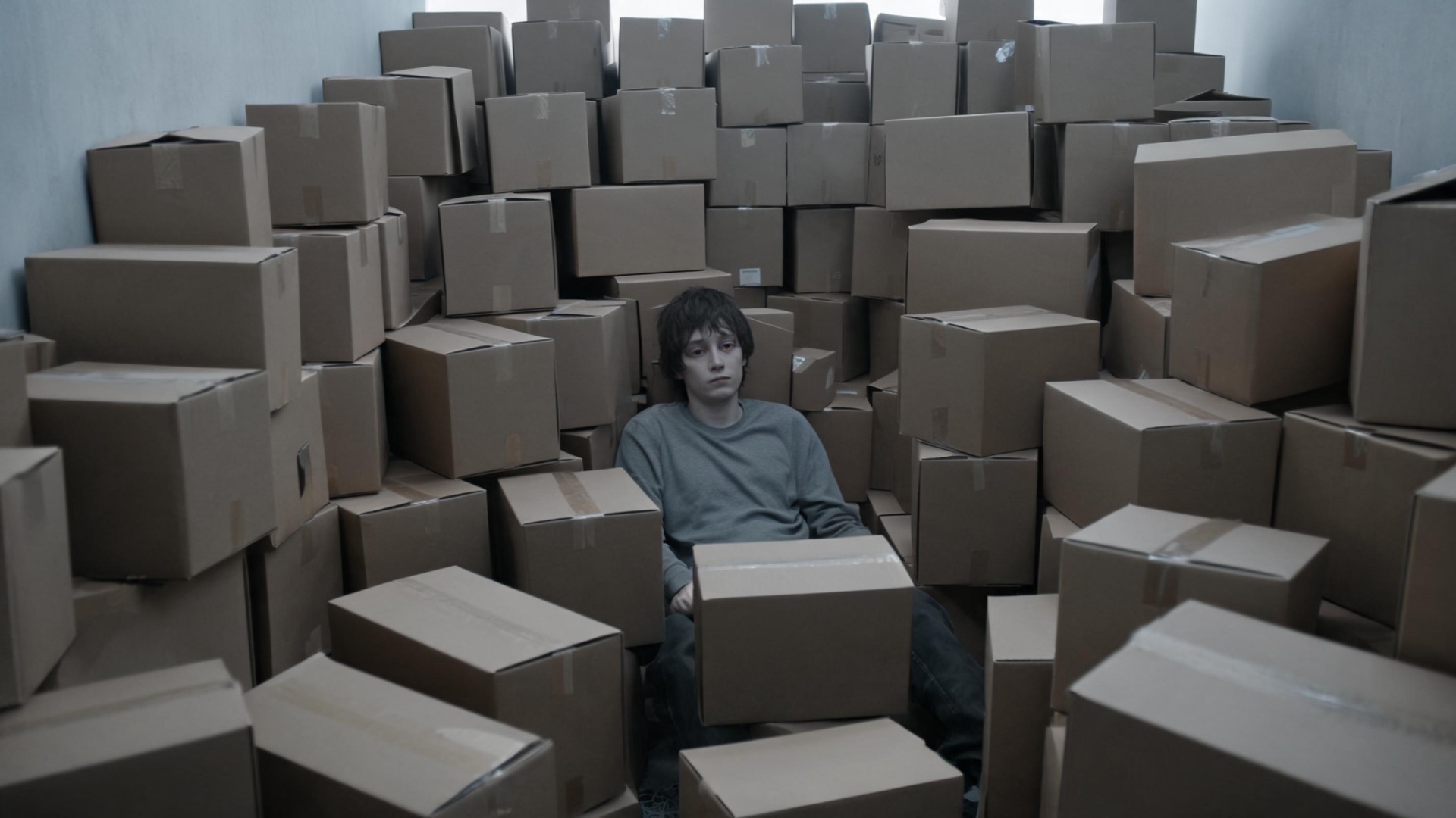 | **B-roll** | `A person surrounded by thousands of Amazon boxes, looking empty and grey.`