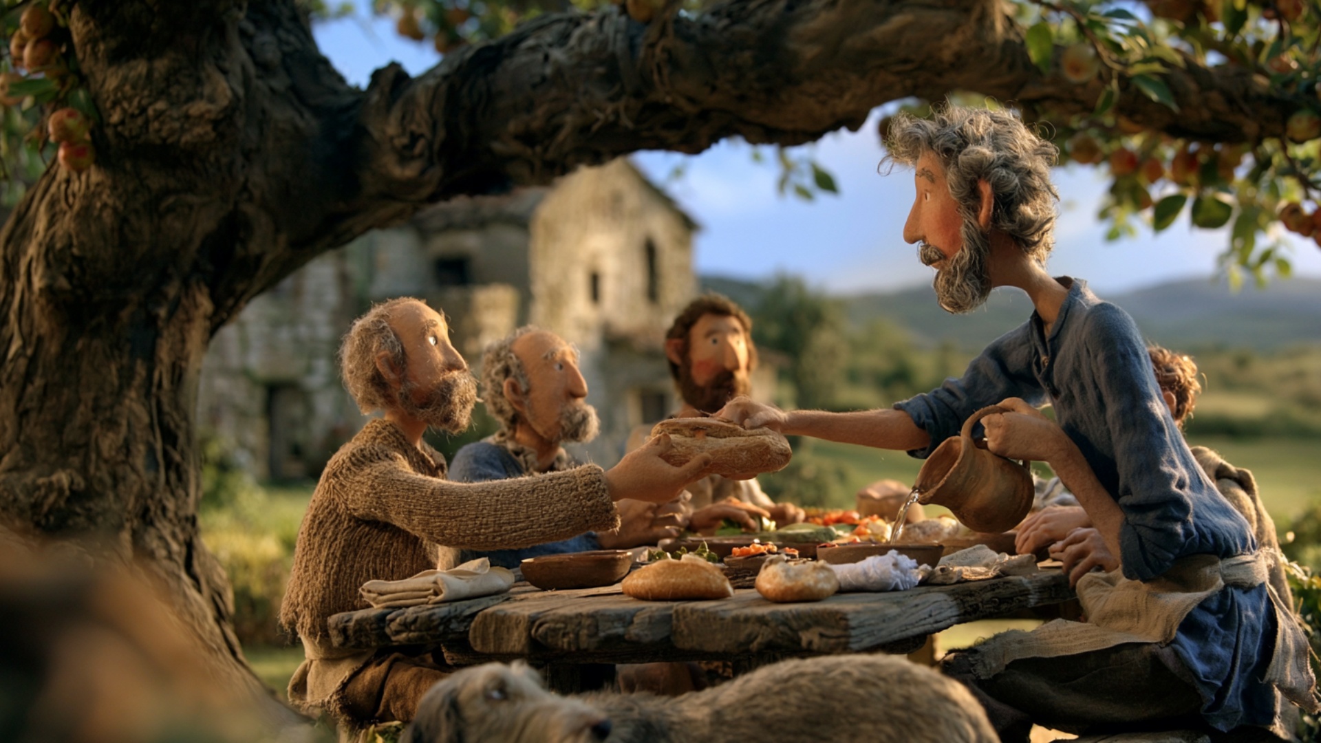 The man on the right steadily passes the loaf of bread across the table to the man opposite him, ...