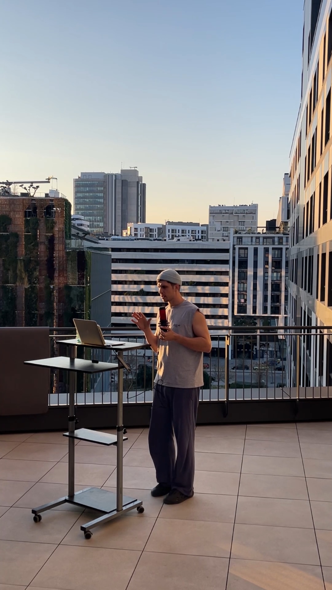 A man on a rooftop terrace suddenly jumps forward off the terrace in a funny exaggerated diving m...