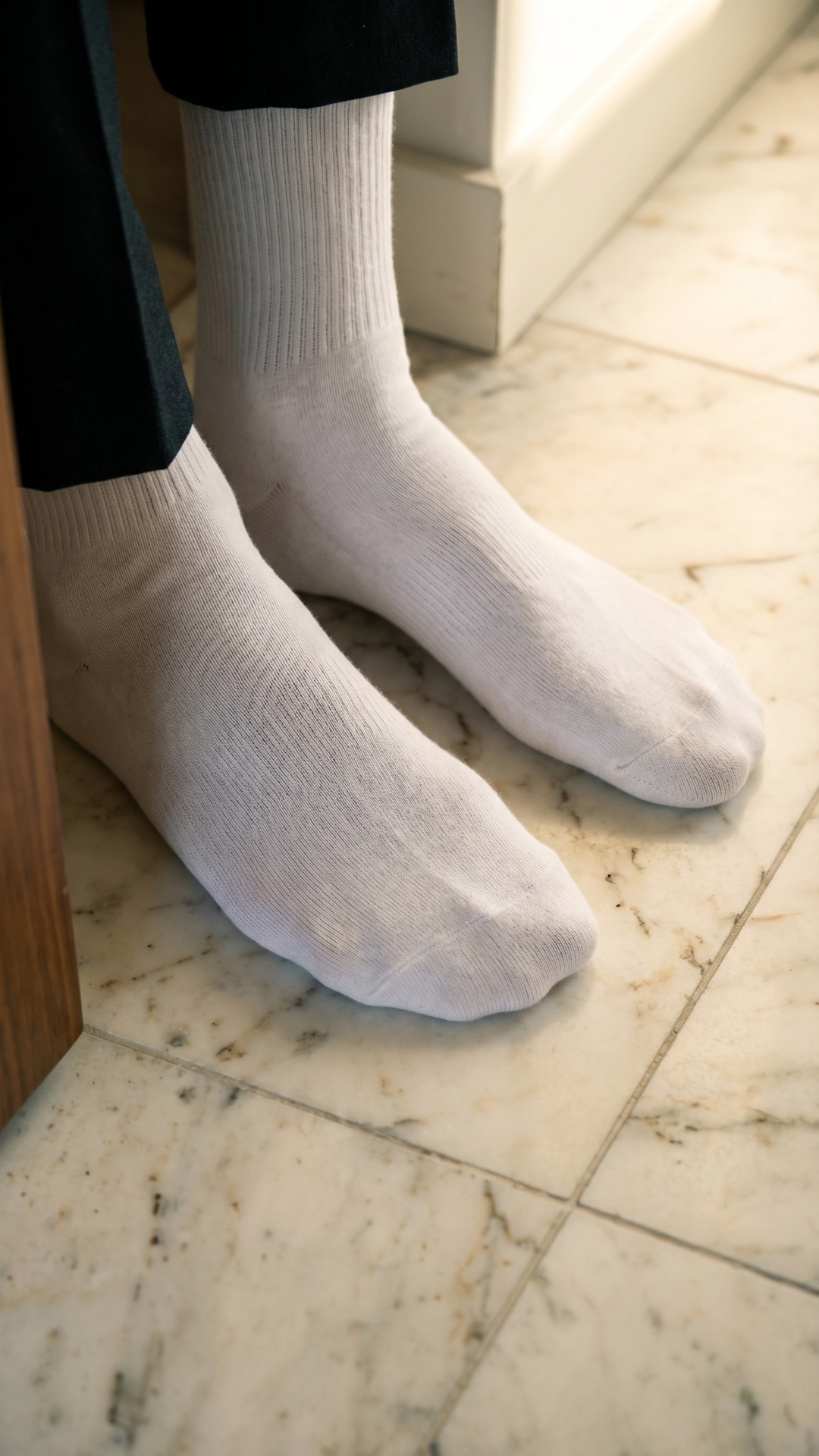 close-up of feet in socks, slight movement, pressure shift, natural breathing, soft lighting chan...