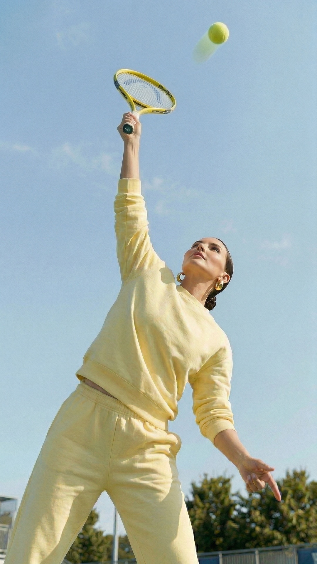 she hits a ball with her racket and ball flies away