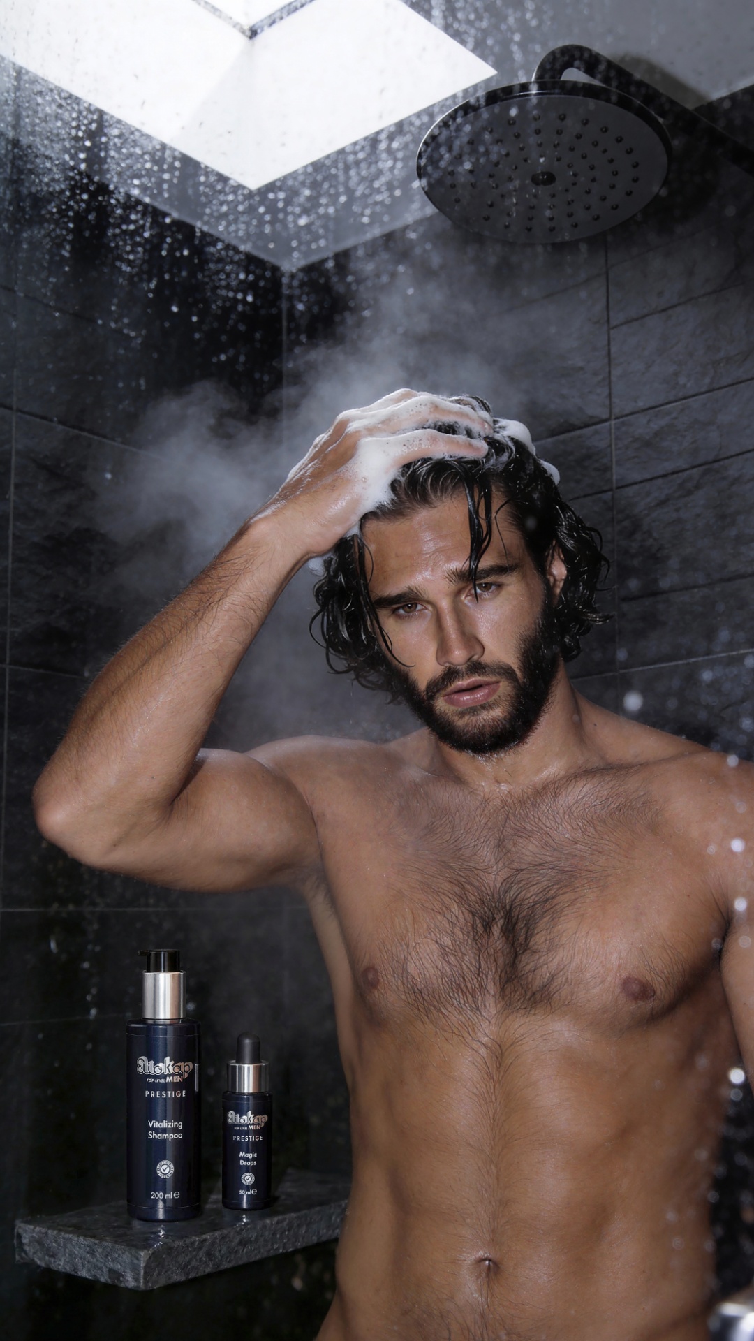 A photorealistic advertising scene set in a shower. An athletic adult man with dark, damp hair wa...