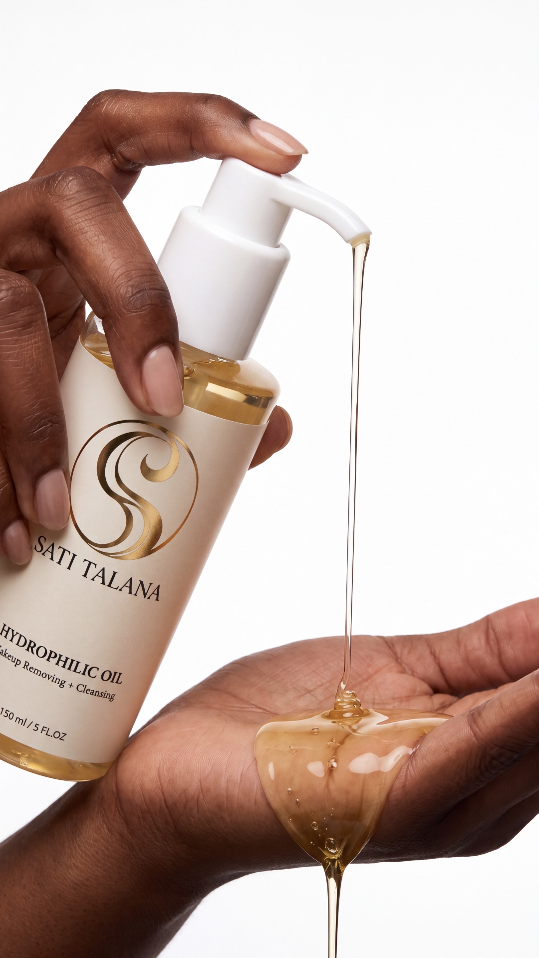 The pump is gently pressed, releasing a smooth golden stream of oil into the palm. Macro shot, sl...