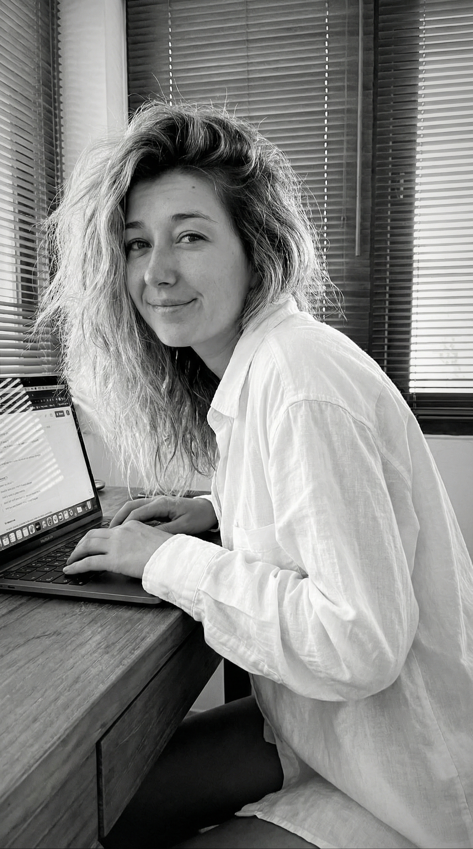 This girl in a white shirt is sitting at a laptop and saying, oh my god, the future is already he...
