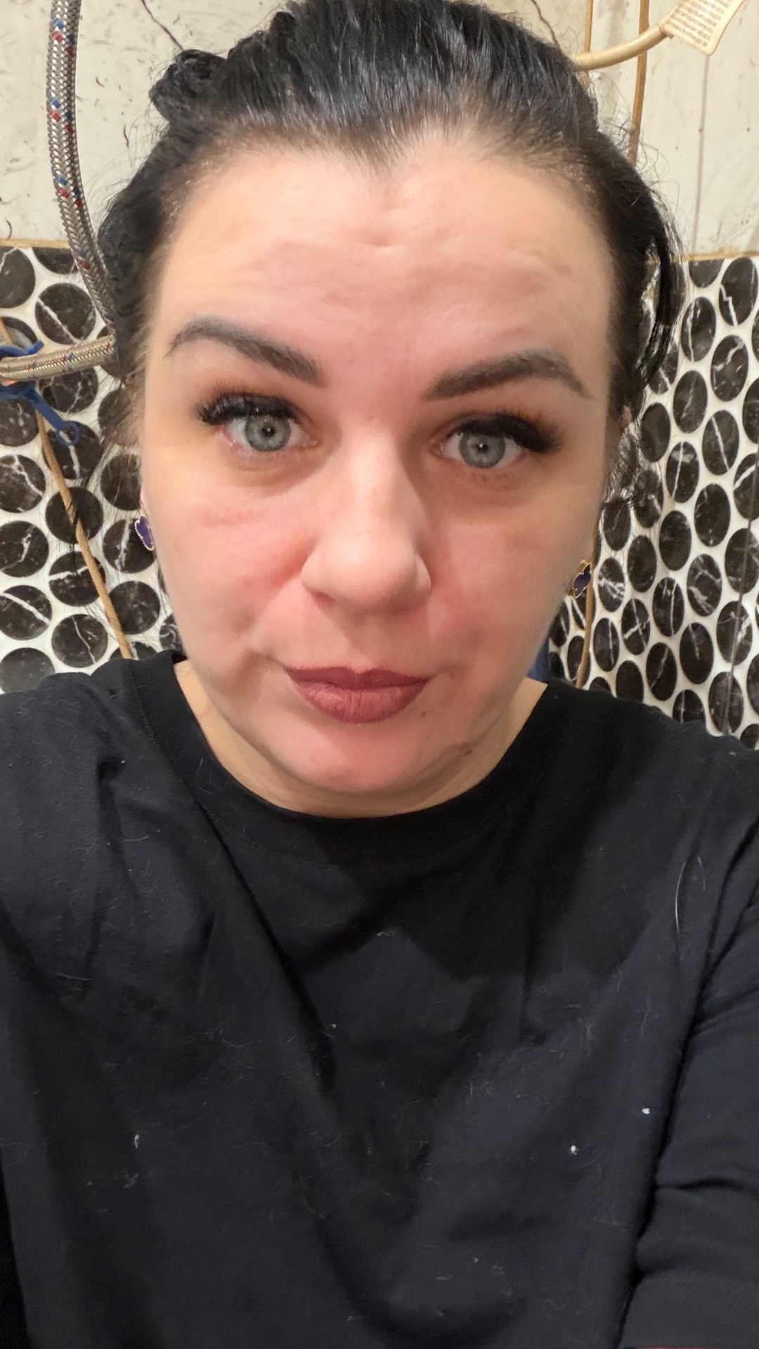 A vertical selfie-style video, as if a young woman is filming everything herself on her phone whi...