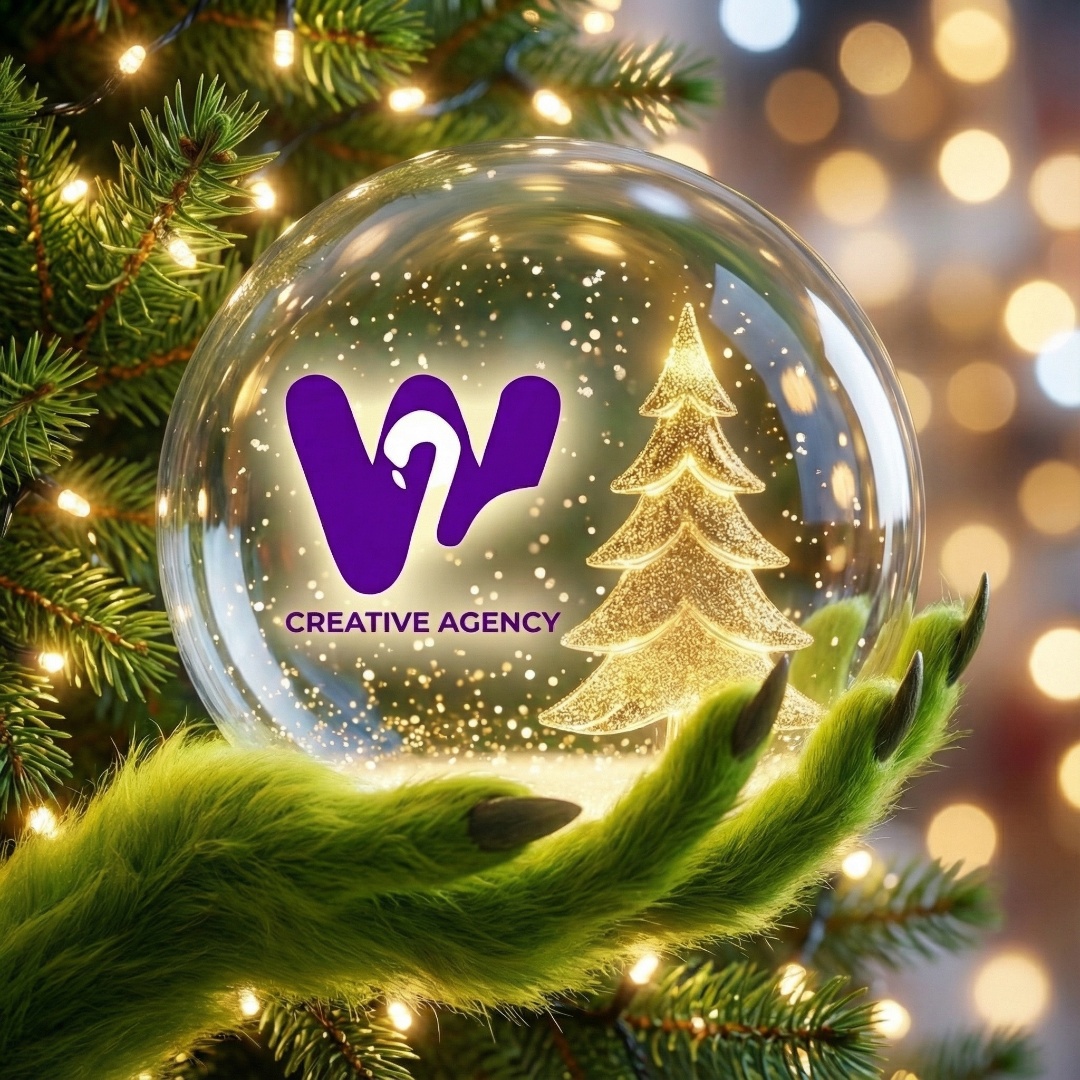 A close-up animation of a glass snow globe hanging on a Christmas tree. A green Grinch hand holds...