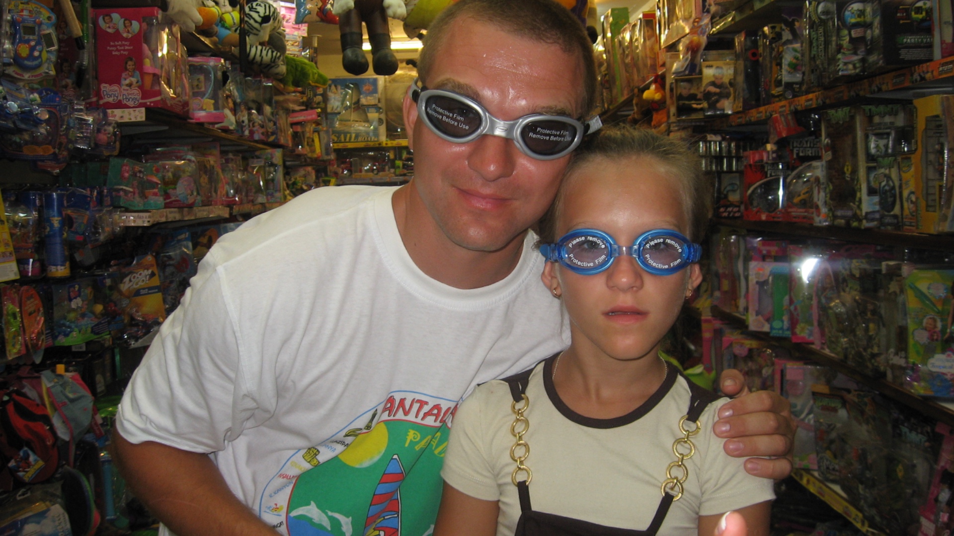 Two people wearing glasses, both take off their glasses simultaneously and then burst into laught...
