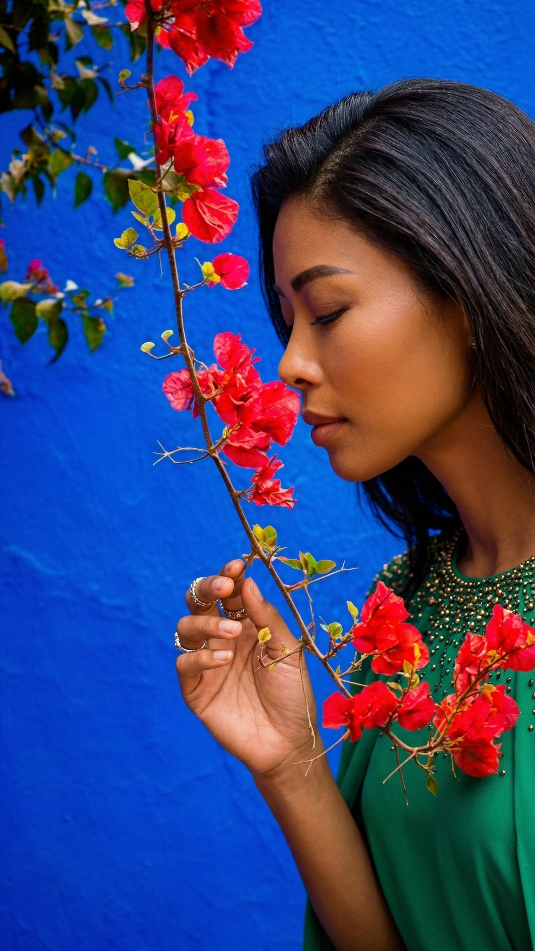she is smelling flowers
