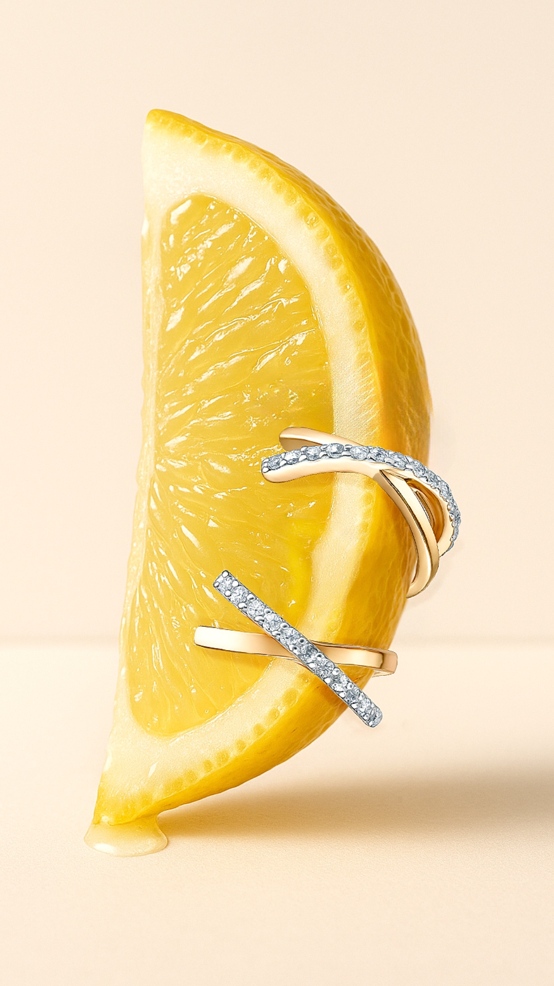 Subject: Lemon wedge with gold earrings adorned with diamonds  
Context: Close-up, macro view wit...