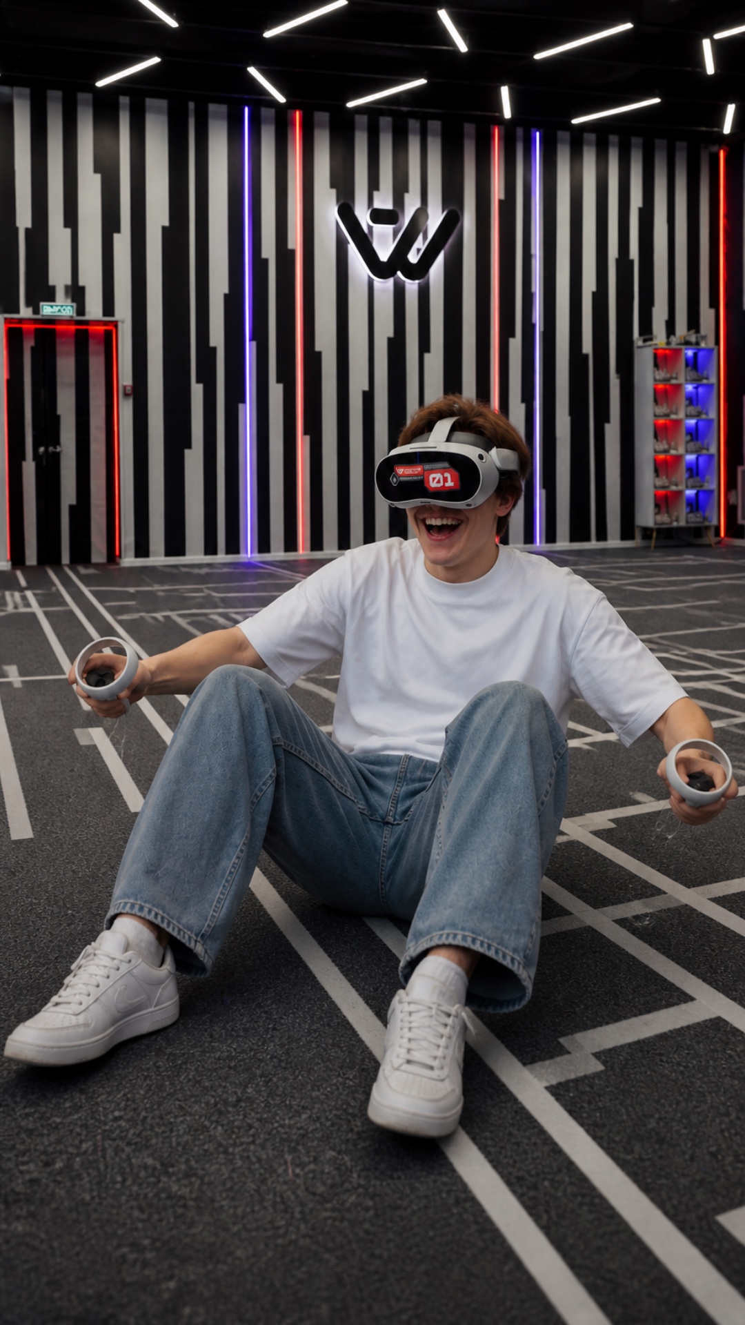 A young man sitting on the floor in a futuristic neon-lit room slowly puts down the VR controller...