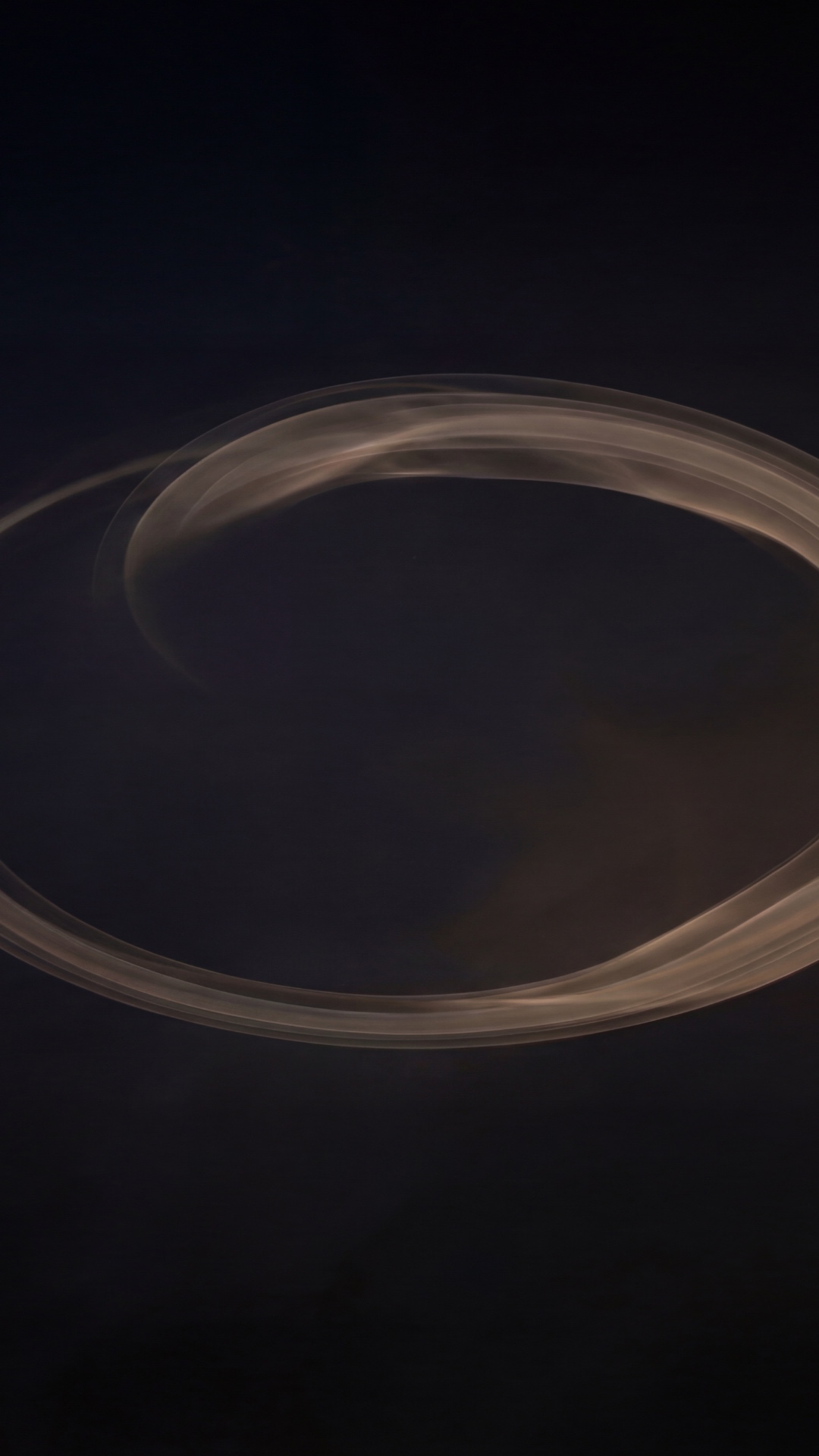 A minimal abstract circular light form slowly breathing in darkness. 
Very slow organic motion, s...