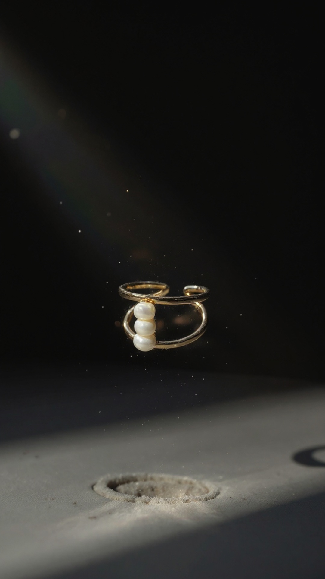 The silver ring slowly levitates above the velvet surface, softly rising into the air. Elegant ci...