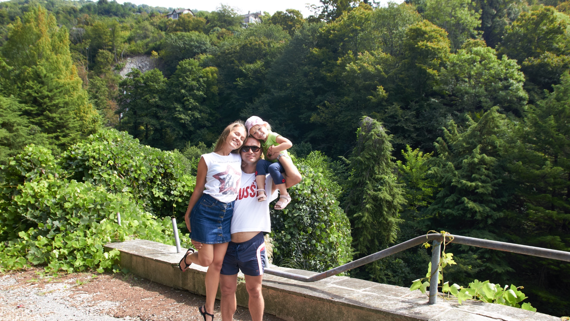 A heartwarming family photo of a father with his teenage daughter standing beside him, and his yo...