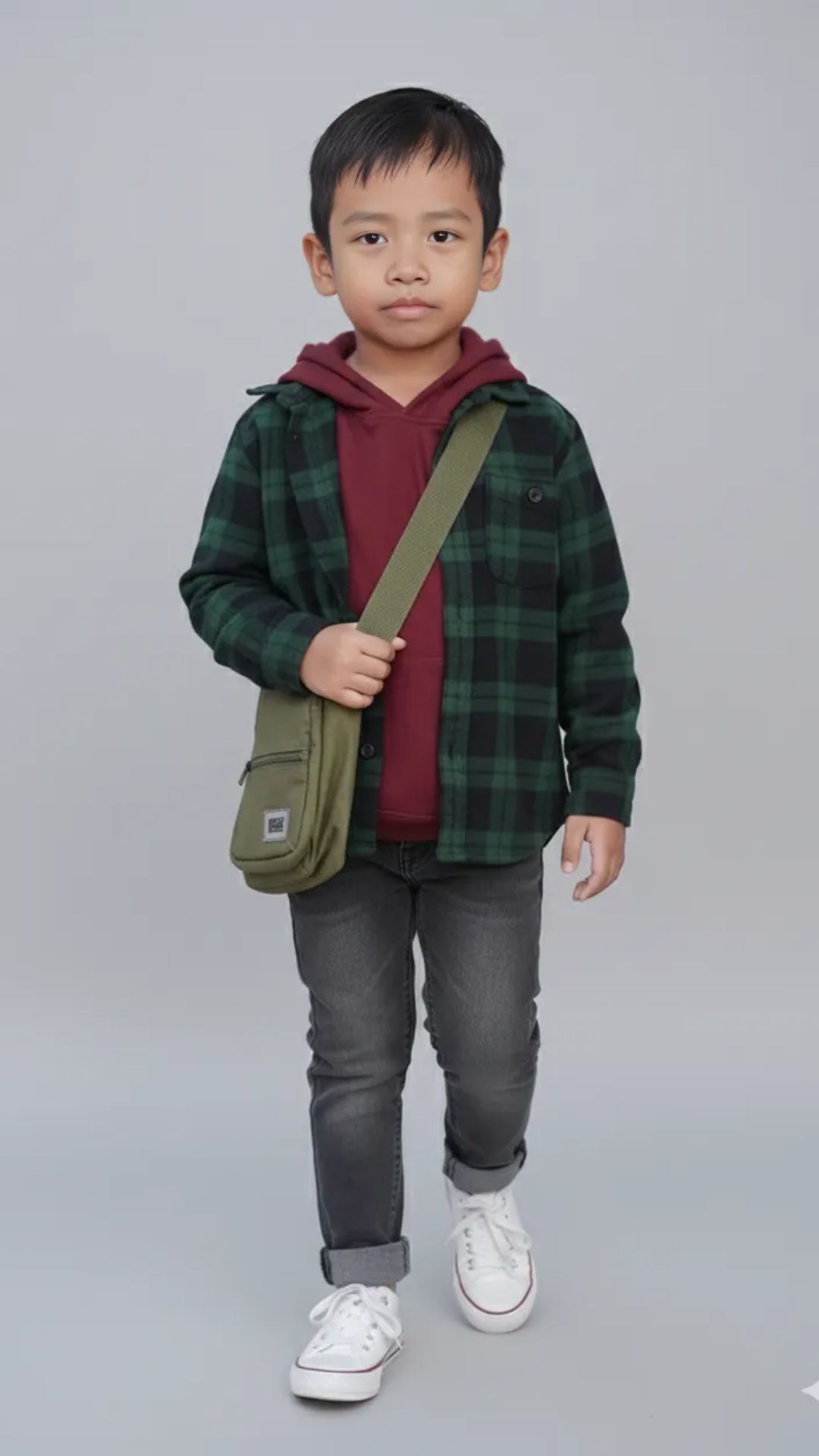 8-second editorial video of a stylish Indonesian child standing confidently in a studio setting, ...