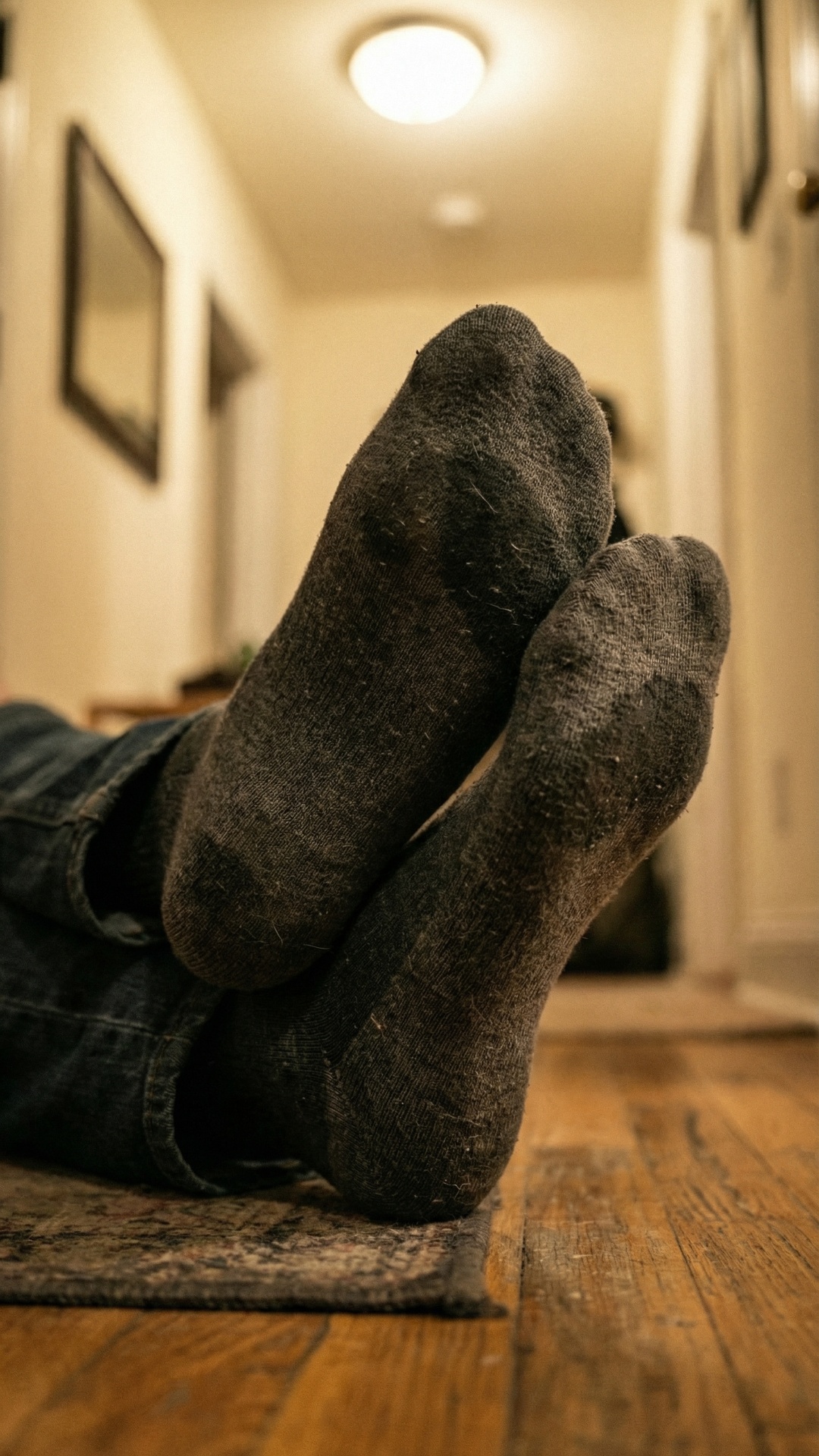 close-up of feet in socks, subtle foot movement, slight pressure shift, natural breathing motion,...