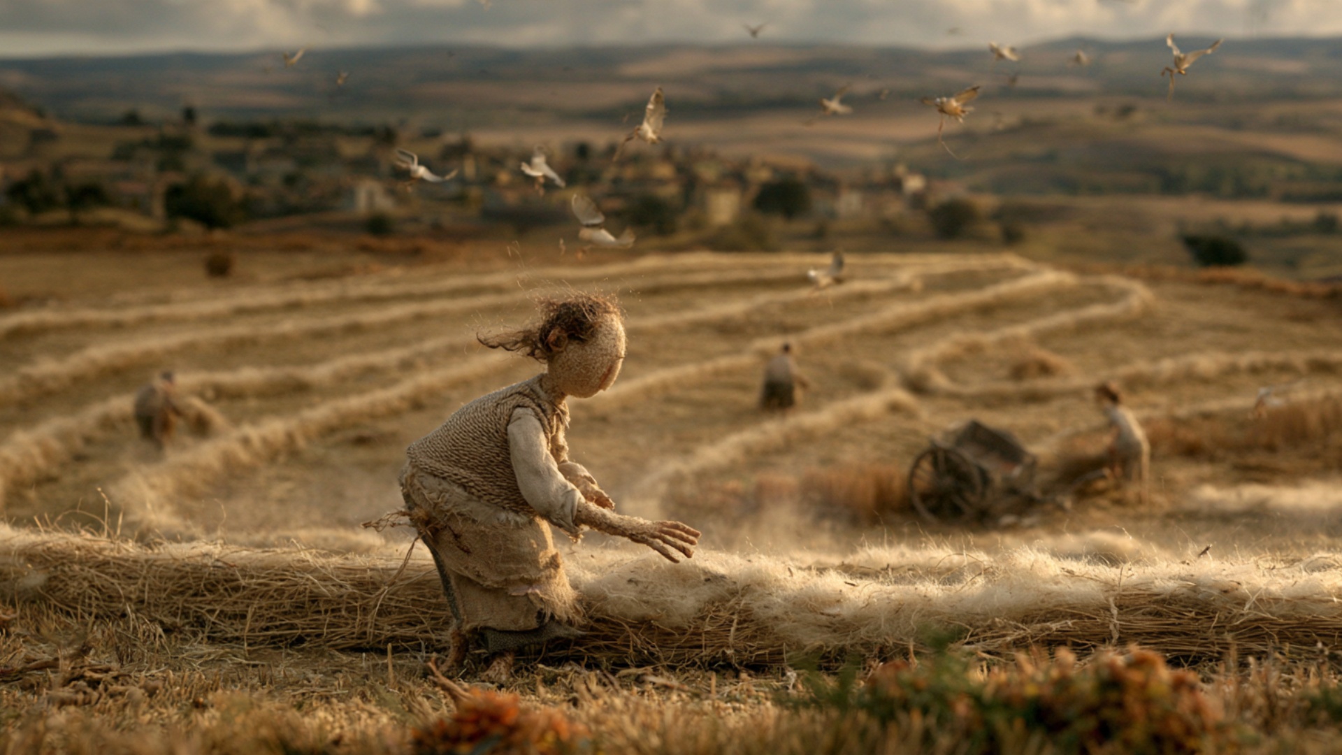 Cinematic tracking movement across the harvested field, keeping the foreground handmade worker in...