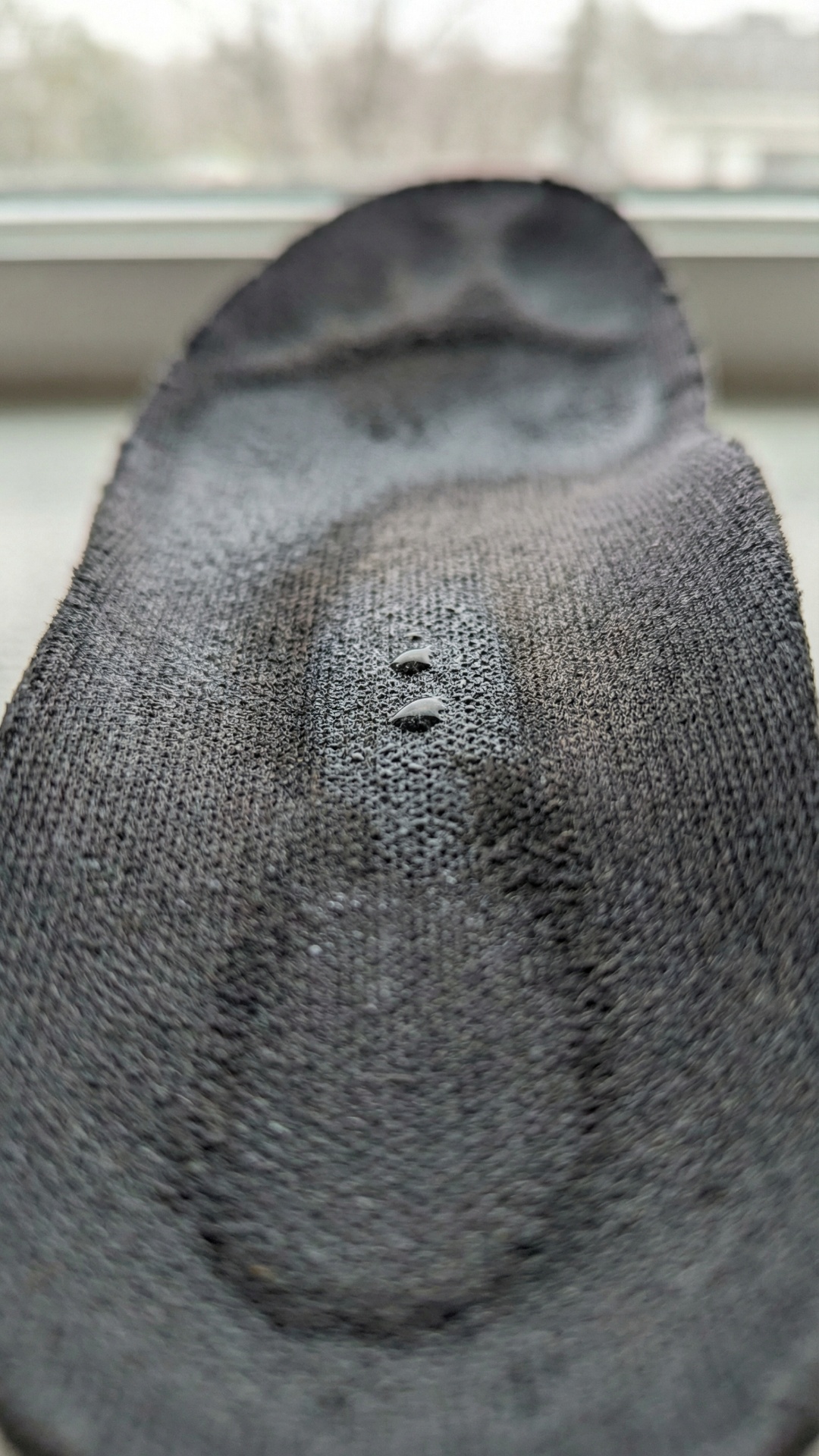 close-up of shoe insole, slight camera push-in, soft light flicker, realistic texture movement, m...
