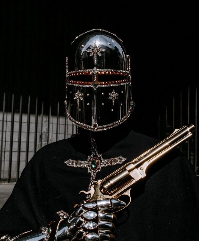 Extreme close-up on the jeweled helmet. 
Smoke drifts slowly across the diamond 
details. A sin...