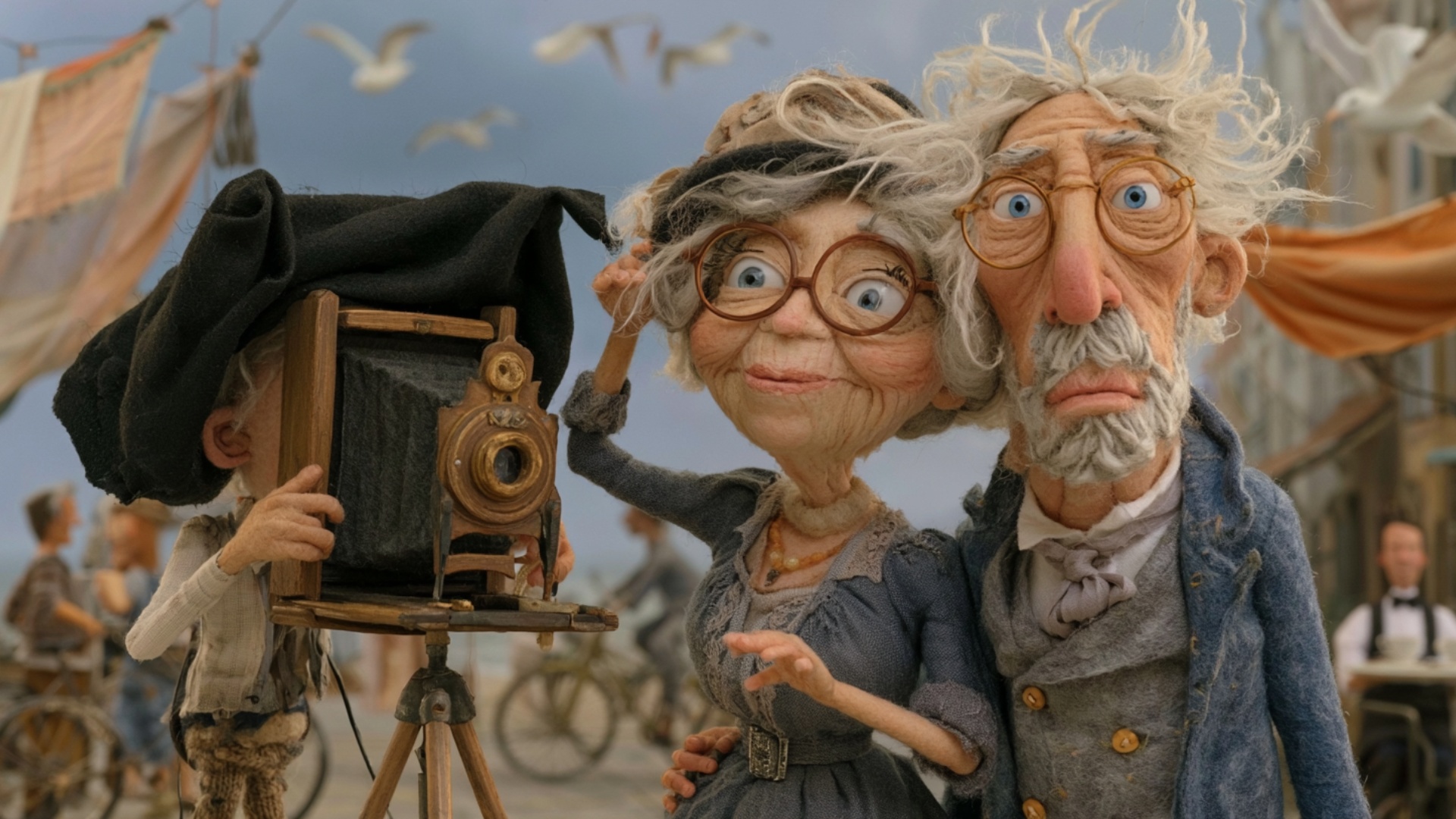 The elderly photographer gives a small hand signal from behind the large camera, asking the coupl...